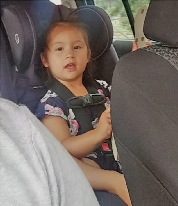 A photo of a child sitting in a car seat